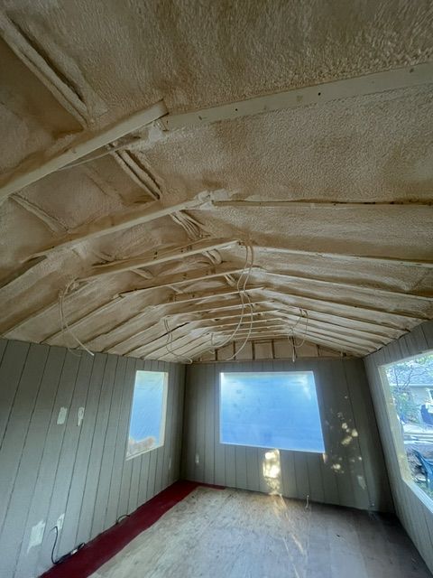 Underside of a cantilevered sunroom floor, spray foamed between the joists above a walkout basement