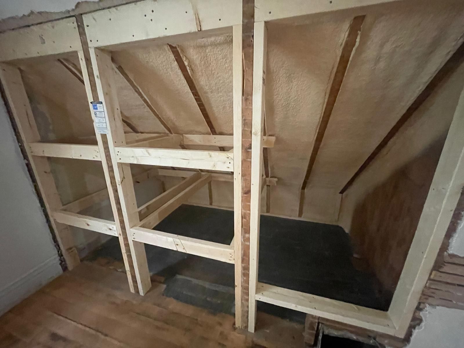 Attic knee-wall framing with closed-cell spray foam applied between the studs and rafters